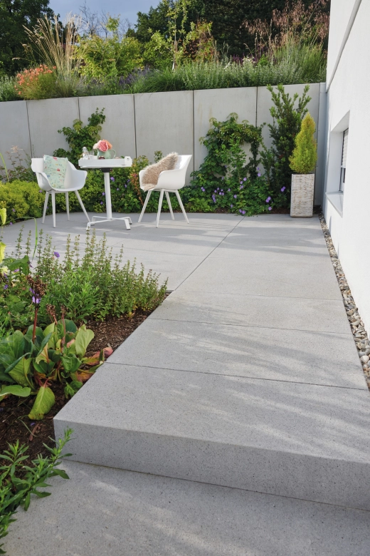 Two chairs on an all-round planted terrace
