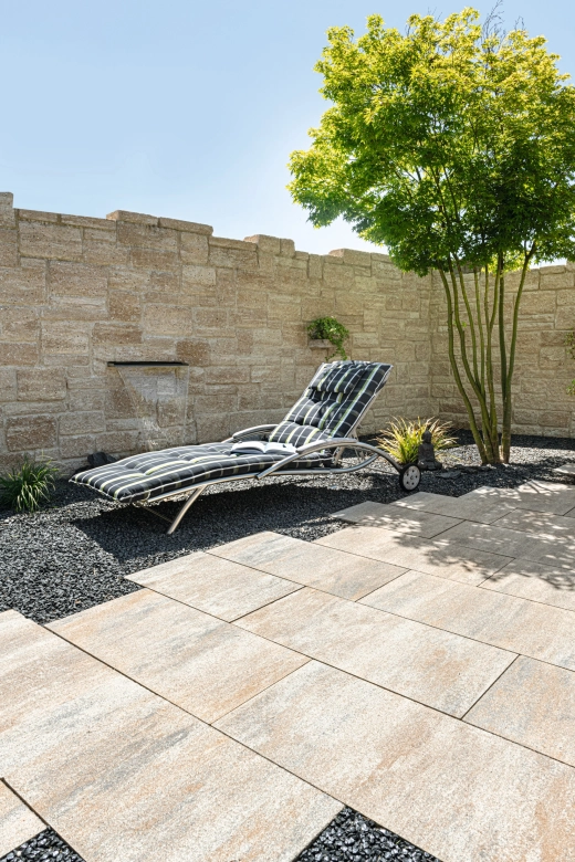 Terrace with terrace slabs and a deck chair