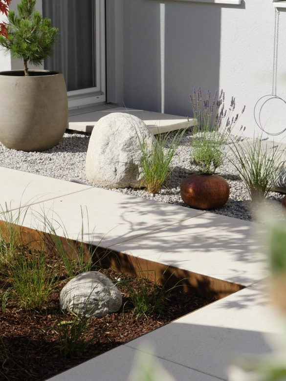 Garden with large-format path and planter.