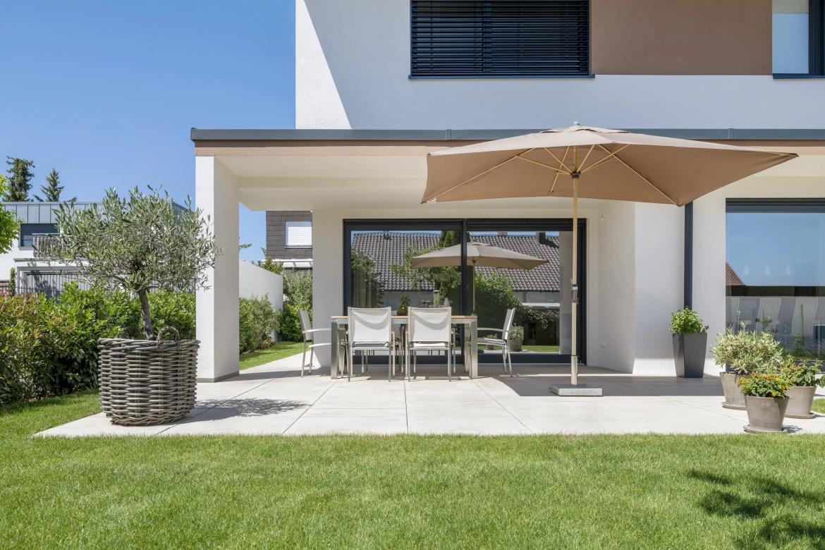 Covered terrace with furniture and a parasol