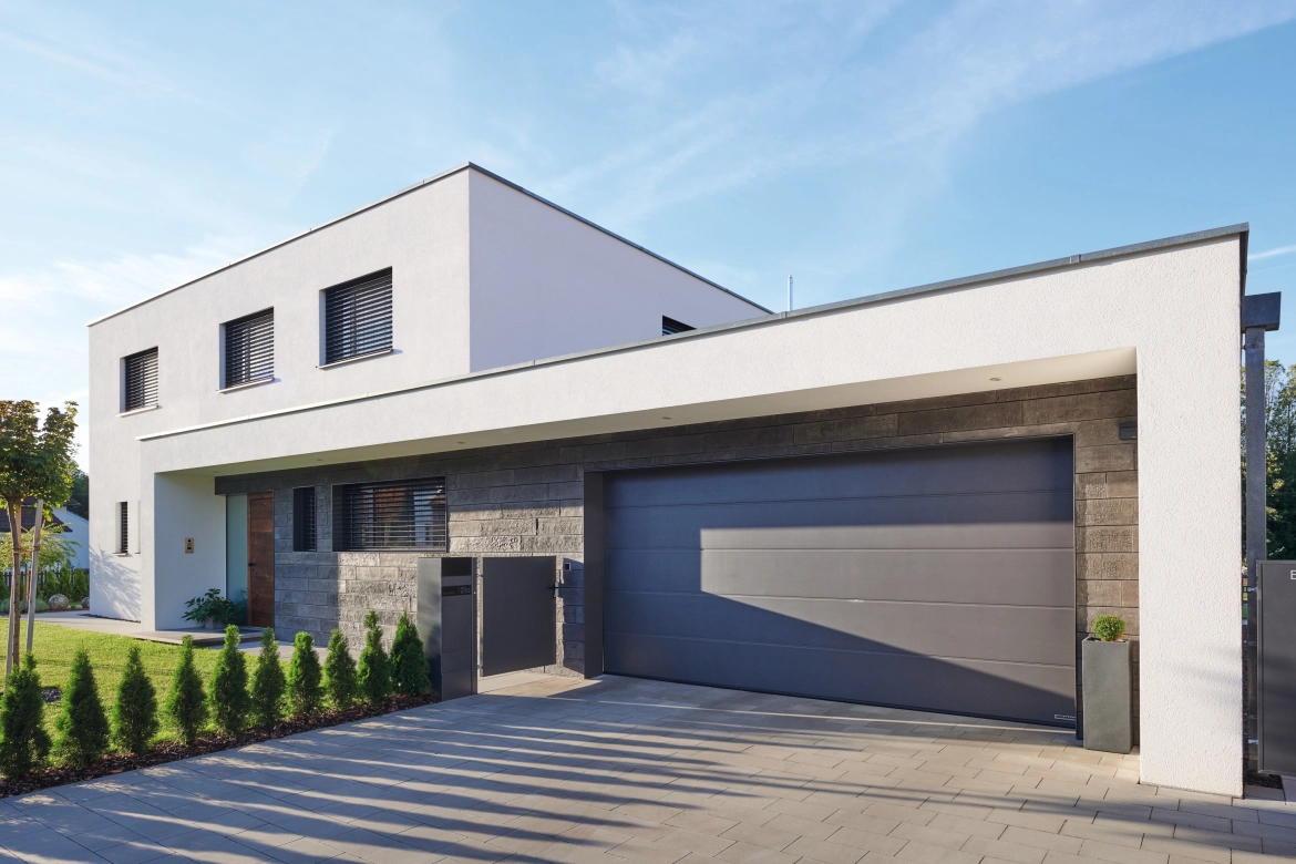 House with integrated garage and wall tiles and paving stones from Godelmann