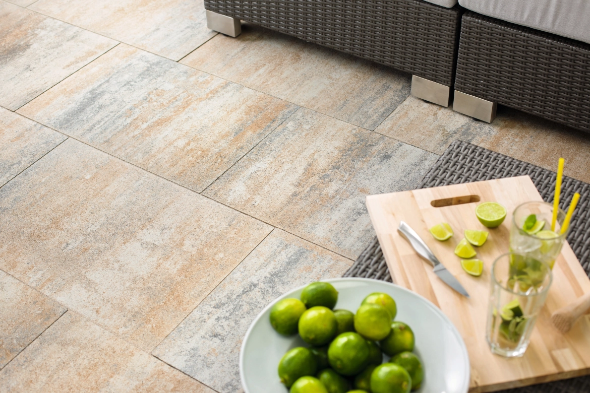Shell-limestone nuanced patio slabs with a table on which cocktails are prepared