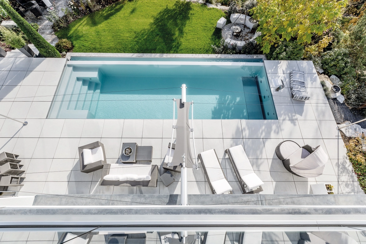 Bird's eye view of a private garden with pool, garden furniture, barbecue station