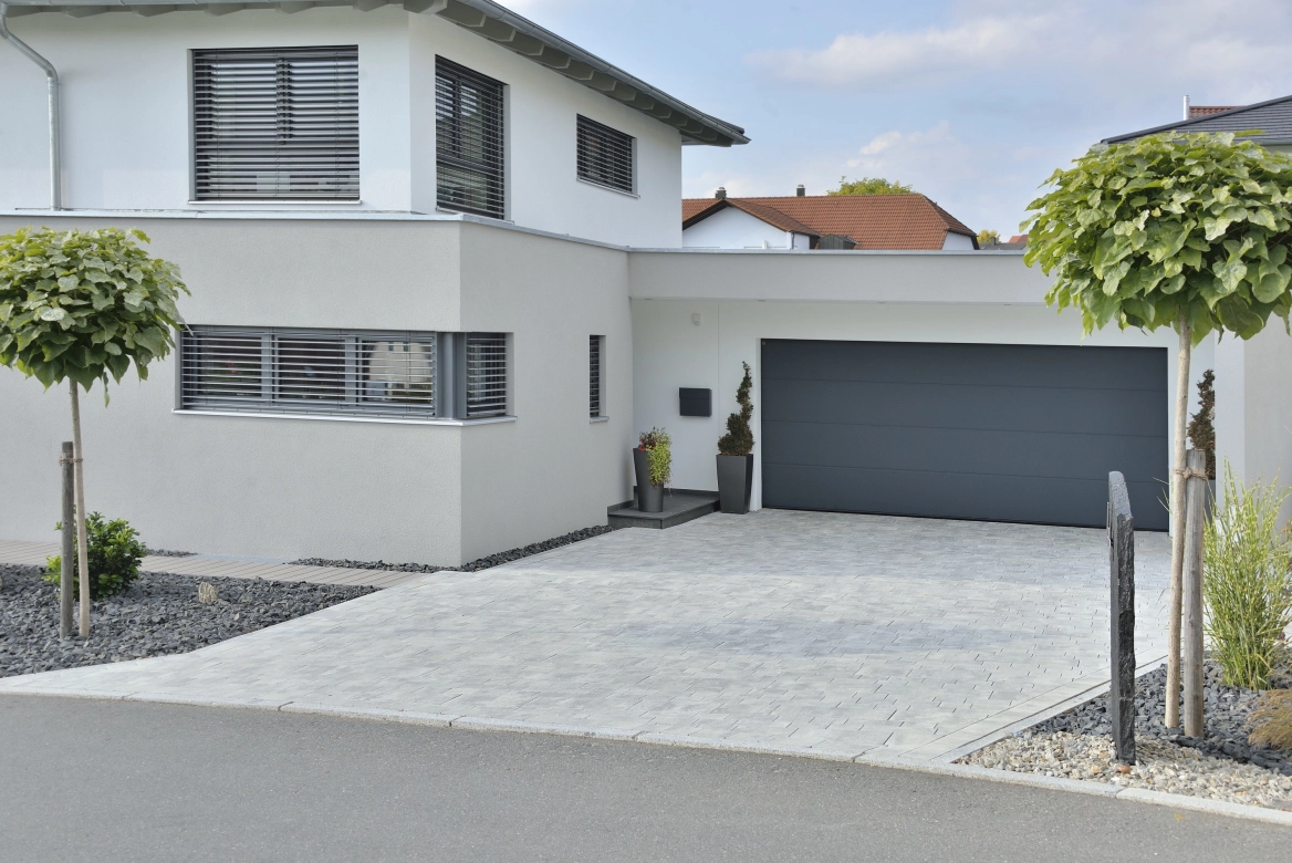 Modern detached house with nuanced paving stones as a courtyard entrance