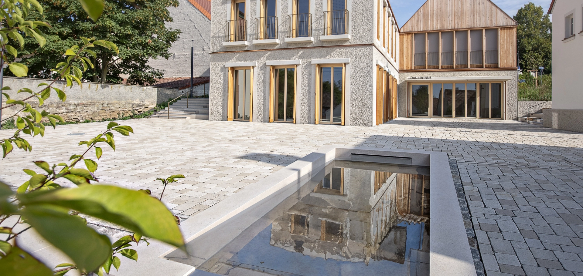 Picture of the Niederwerrn community center with the climate stone as ecological paving