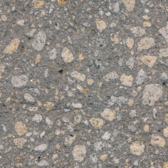 Concrete surface pattern in dark gray with beige inclusions of coarse gravel