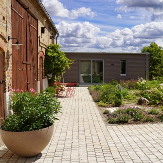 Farmhouse with modern extension and Acentro paving stone
