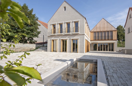 Restored buildings with a mixture of classic and modern architecture and a square with ecological paving.