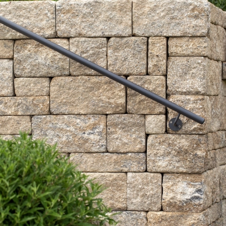 Shell-limestone-colored wall with railing.