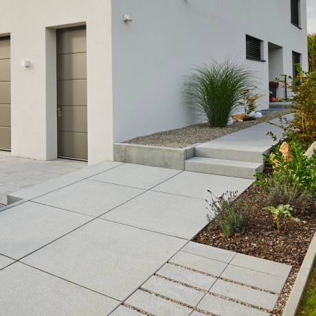 Entrance to a detached house with a double garage.