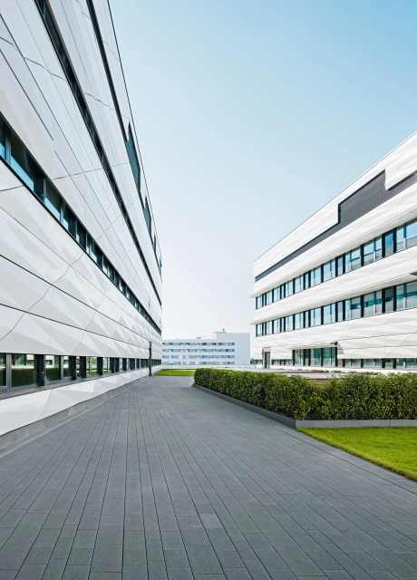 Extensive landscaped and paved area between two modern office buildings
