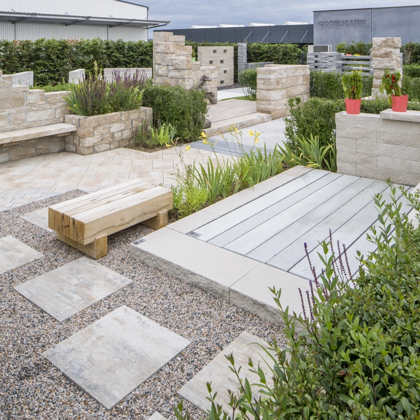 Rustic garden with patio slabs, walls, steps and benches.