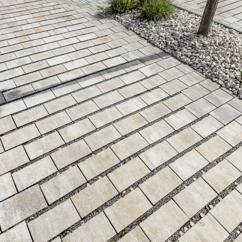 Paved area with paving stones and lawn liner in combination.