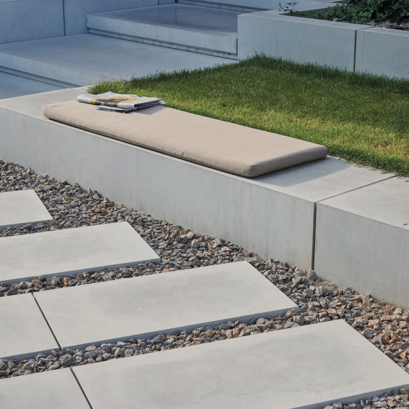 Steps, slabs and seating elements made of high-performance concrete with decoration in a private garden.