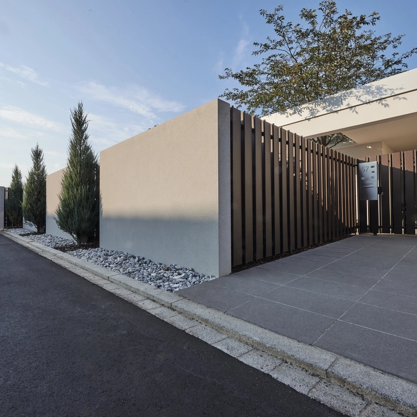 Solid wall made of high-performance concrete as a privacy screen around a private property.