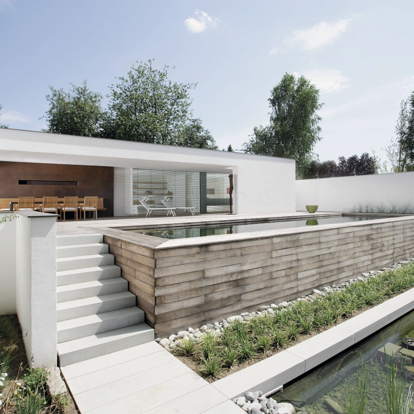 Private property with two pools and steps leading up to the terrace entrance.