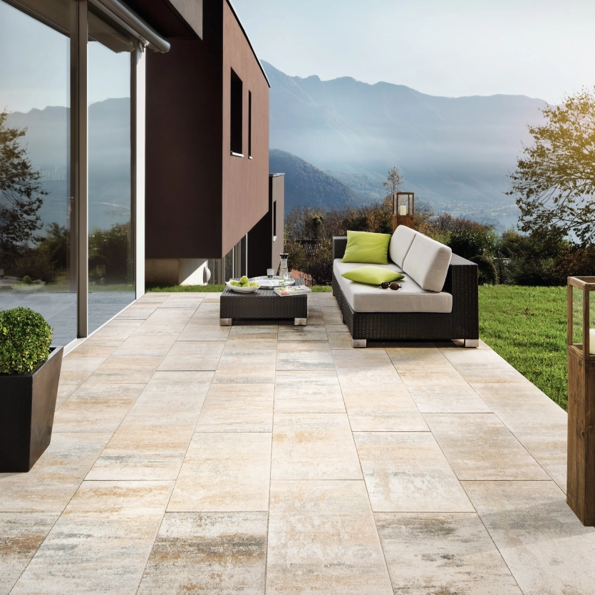 Shell-limestone-colored terrace of a modern house with mountain view.
