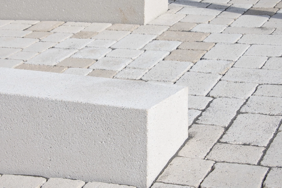 Concrete benches on an ecological paving in a public space.